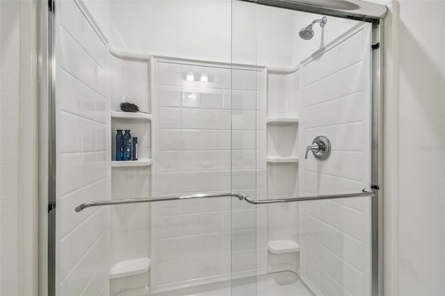 bathroom with a shower with door