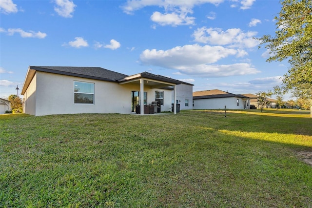 rear view of property with a yard