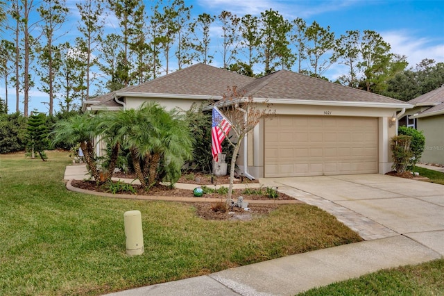 view of front of house featuring a front lawn and a garage