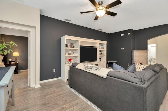 living room featuring ceiling fan and light hardwood / wood-style flooring