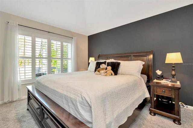 bedroom featuring light carpet