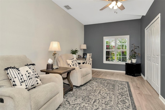 living room with ceiling fan and hardwood / wood-style floors