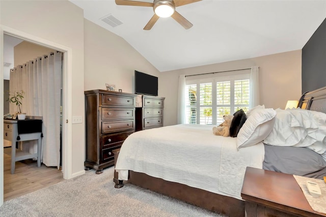 bedroom with ceiling fan, light colored carpet, and lofted ceiling