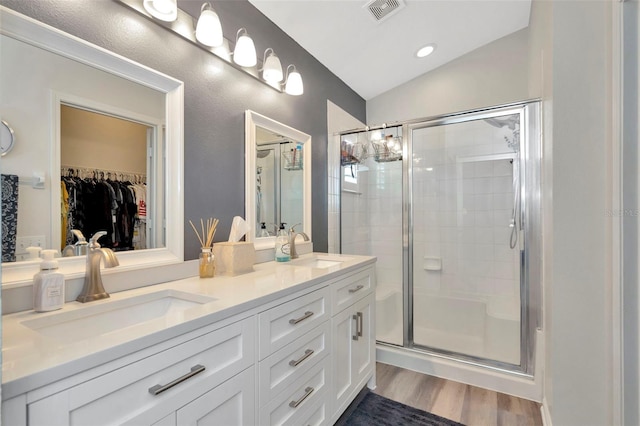 bathroom with vanity, an enclosed shower, lofted ceiling, and wood-type flooring