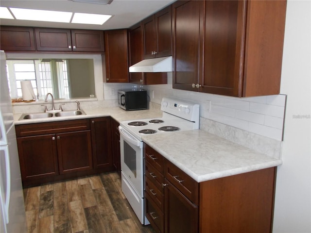 kitchen featuring decorative backsplash, dark hardwood / wood-style flooring, white appliances, and sink