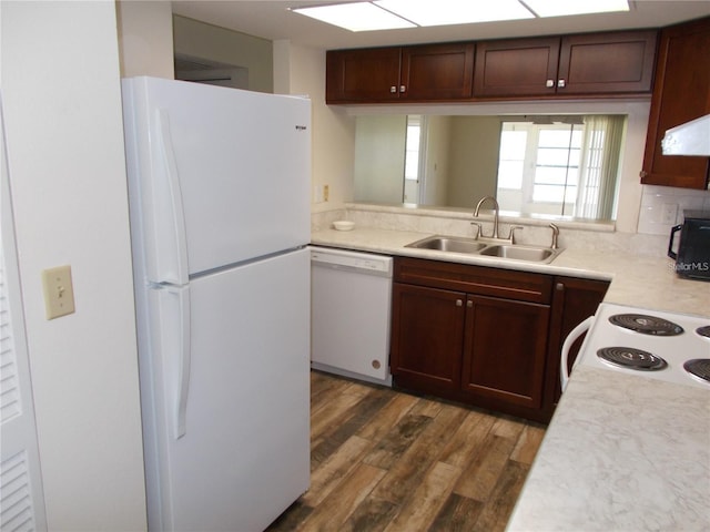 kitchen featuring backsplash, dark hardwood / wood-style flooring, sink, and white appliances