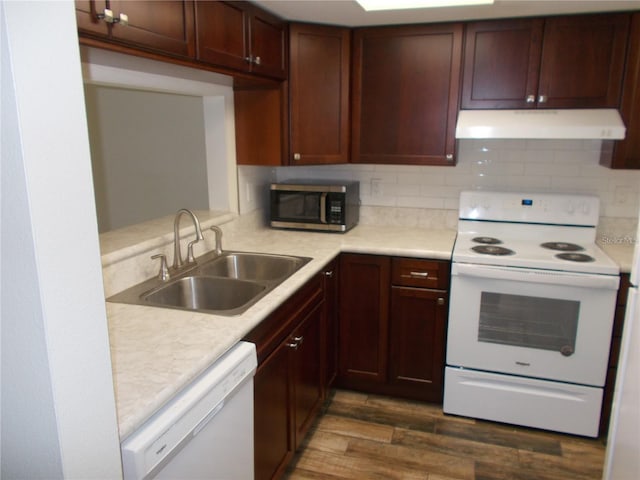 kitchen with decorative backsplash, sink, dark wood-type flooring, and white appliances