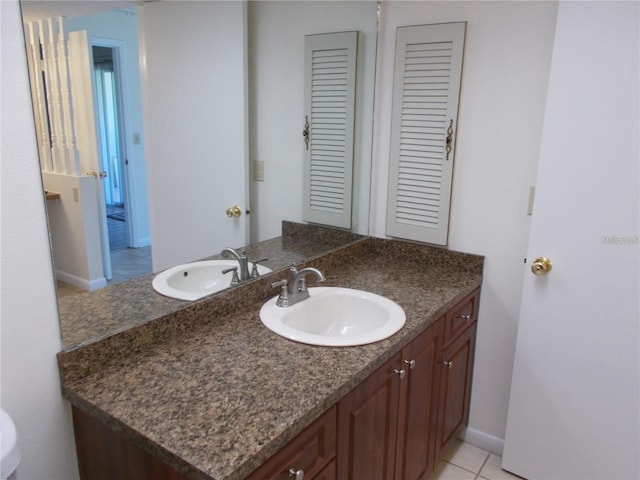 bathroom with tile patterned floors and vanity