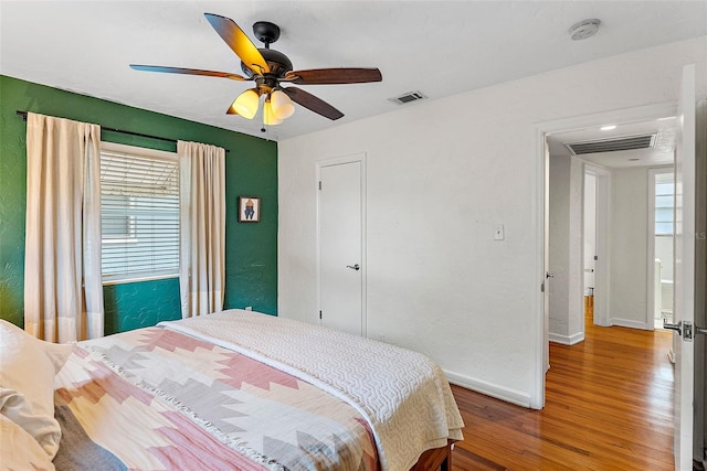 bedroom with ceiling fan and wood-type flooring