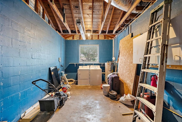 basement with electric water heater and separate washer and dryer