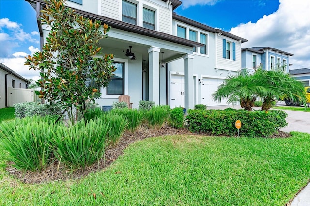 view of front of property with a front yard and a garage