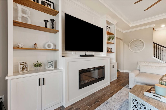 living room with crown molding, dark hardwood / wood-style flooring, and ceiling fan