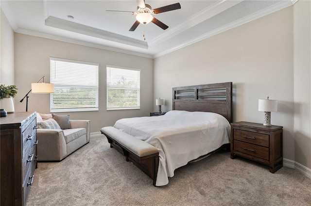 carpeted bedroom featuring a raised ceiling, ceiling fan, and ornamental molding