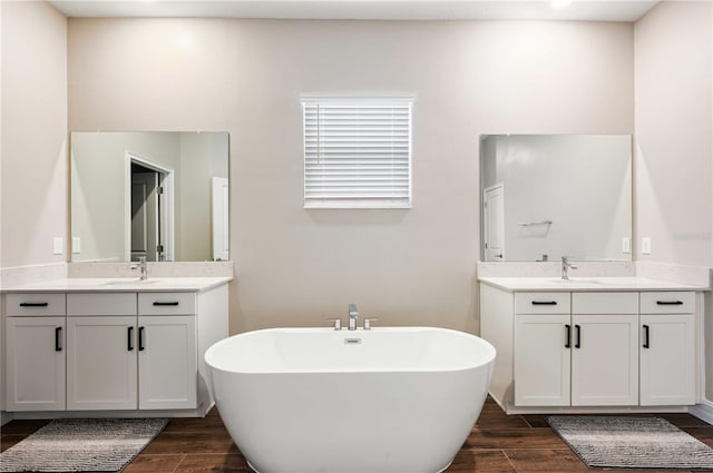 bathroom with vanity, hardwood / wood-style flooring, and a bathtub