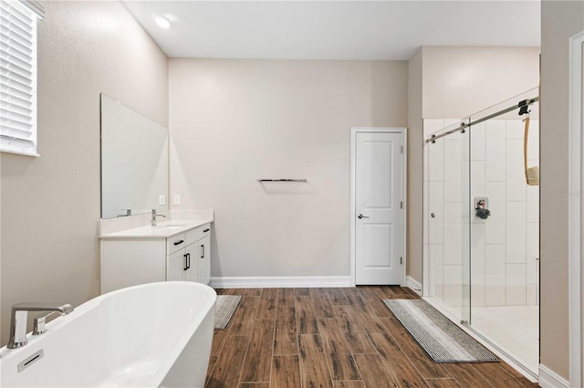 bathroom featuring vanity, separate shower and tub, and wood-type flooring