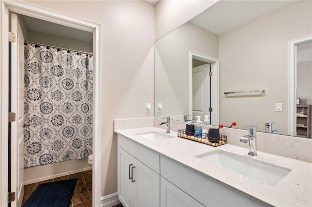 full bathroom with hardwood / wood-style floors, vanity, toilet, and shower / tub combo with curtain