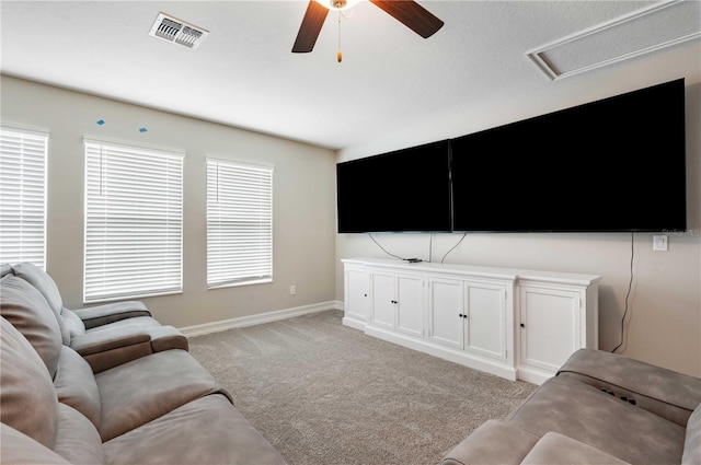 carpeted living room featuring ceiling fan