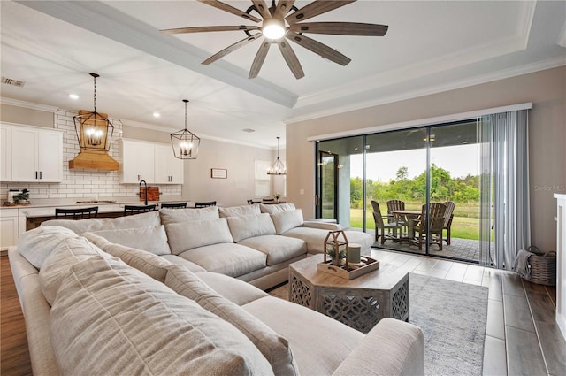 living room featuring ceiling fan, light hardwood / wood-style flooring, sink, and ornamental molding