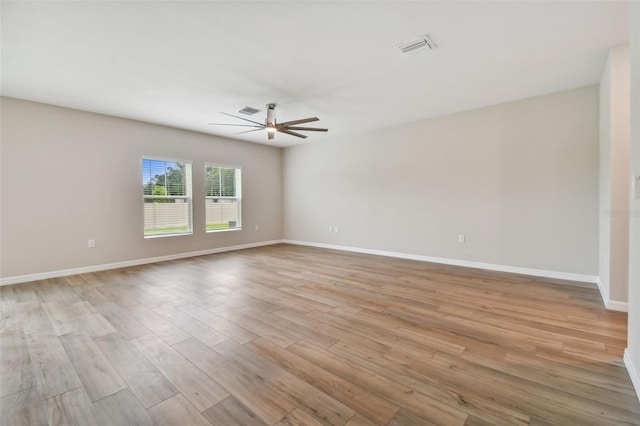 empty room featuring ceiling fan and light hardwood / wood-style floors