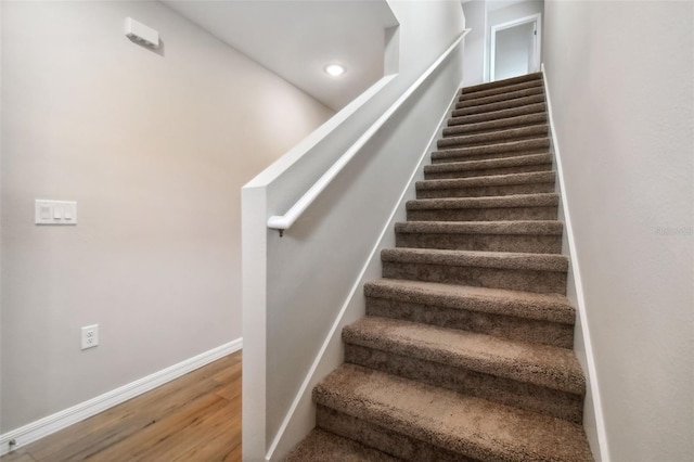 stairs featuring wood-type flooring