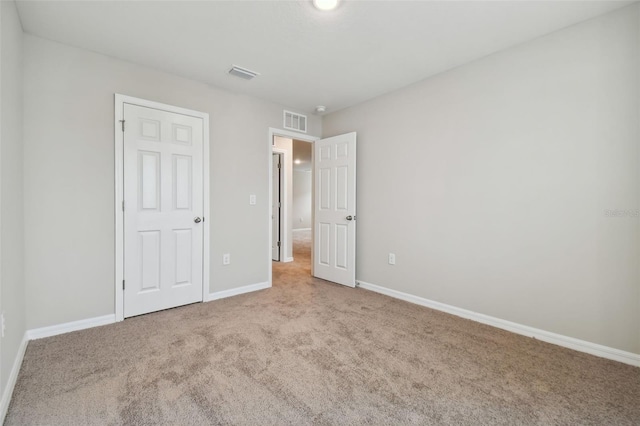 unfurnished bedroom featuring light colored carpet