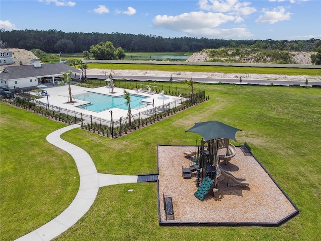 exterior space with a playground and a lawn