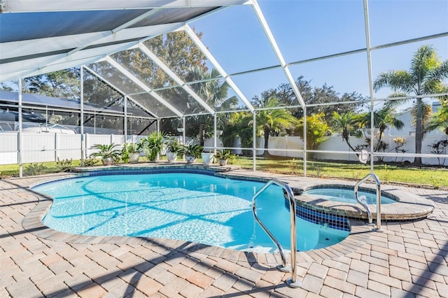 view of swimming pool featuring an in ground hot tub, a patio area, and a lanai