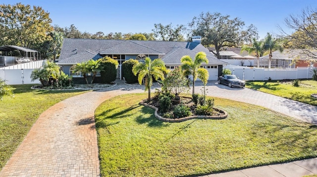 view of front of property featuring a front yard and a garage