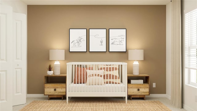 carpeted bedroom featuring multiple windows and a nursery area