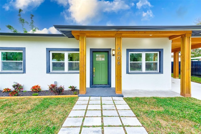 entrance to property featuring a yard