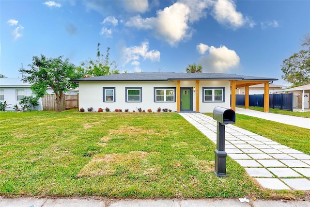 view of front of property with a front yard and a carport