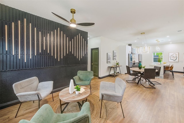 living room with light wood-type flooring and ceiling fan