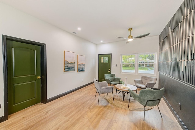 sitting room featuring ceiling fan and light hardwood / wood-style flooring