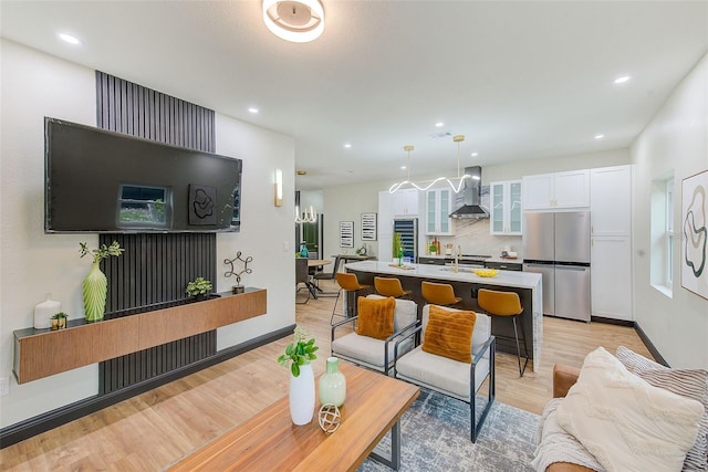 living room with light hardwood / wood-style floors and sink