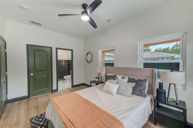 bedroom with connected bathroom, ceiling fan, and light hardwood / wood-style floors