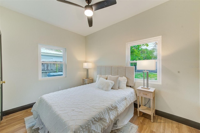 bedroom with ceiling fan and light hardwood / wood-style floors