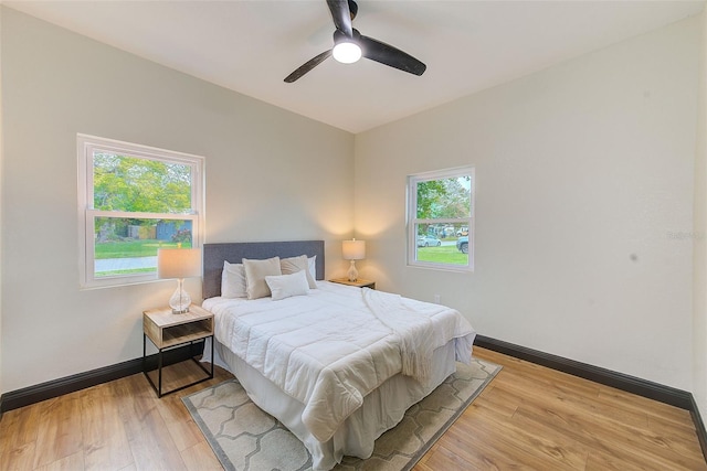 bedroom with ceiling fan and light hardwood / wood-style floors