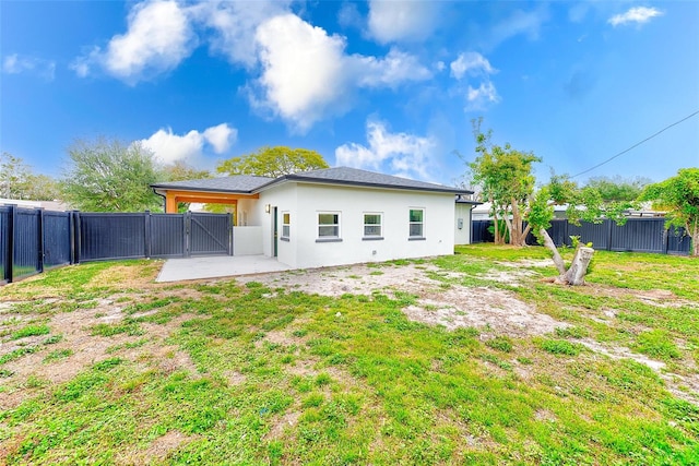 rear view of property featuring a yard