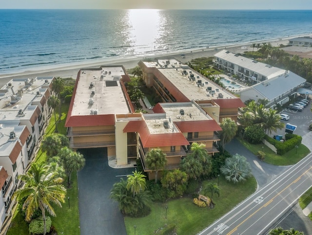 birds eye view of property with a beach view and a water view