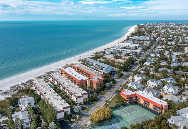 bird's eye view featuring a water view and a beach view