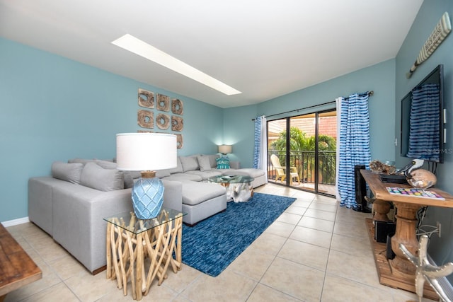 tiled living room featuring a skylight