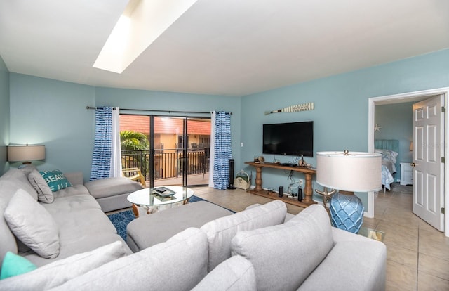 living room featuring light tile patterned flooring and a skylight