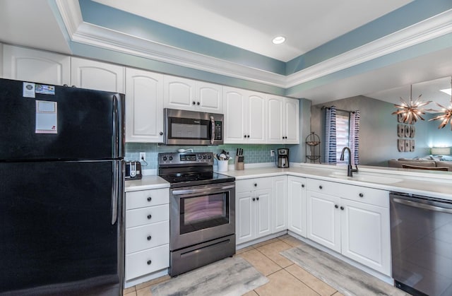 kitchen with white cabinets, appliances with stainless steel finishes, backsplash, and sink