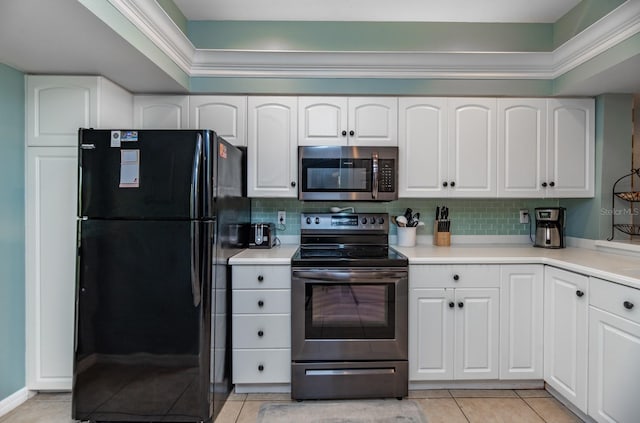 kitchen featuring decorative backsplash, appliances with stainless steel finishes, white cabinetry, and light tile patterned flooring