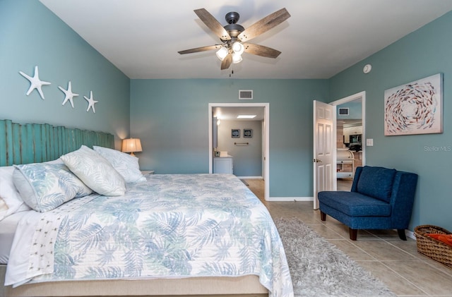 tiled bedroom with connected bathroom and ceiling fan