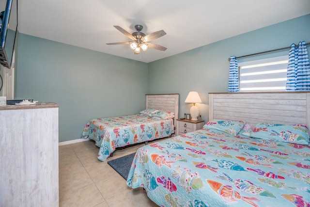 bedroom with ceiling fan and light tile patterned flooring