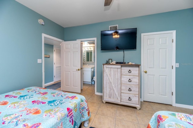 tiled bedroom featuring ensuite bath, ceiling fan, and sink