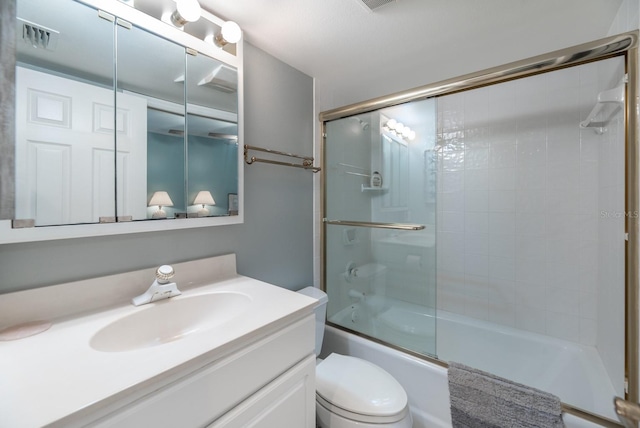 full bathroom with toilet, vanity, and combined bath / shower with glass door