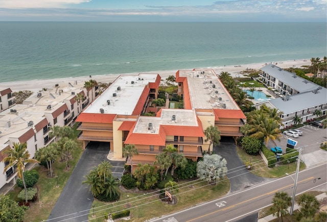 drone / aerial view featuring a water view and a beach view