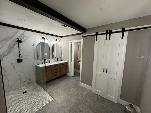 bathroom featuring beamed ceiling, vanity, and tiled shower